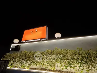 Modern rooftop garden with ambient lighting and decorative wall