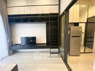 Modern living room with sleek TV unit and adjacent kitchen area