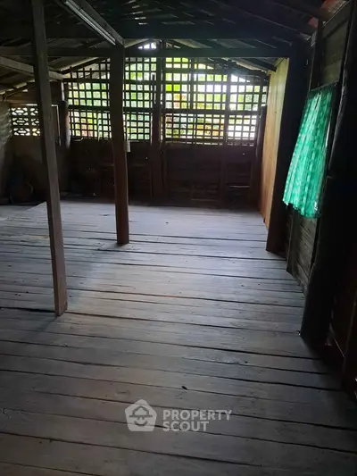 Rustic wooden interior with natural light and open space, ideal for creative renovation.
