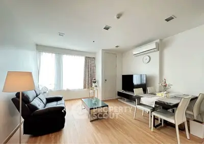 Modern living room with sleek furniture and natural light, perfect for relaxation and entertainment.