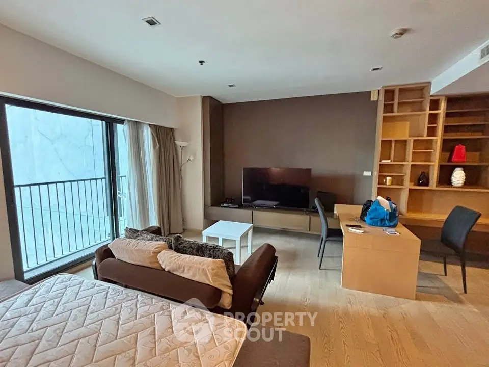 Spacious living room with modern furniture and large window view