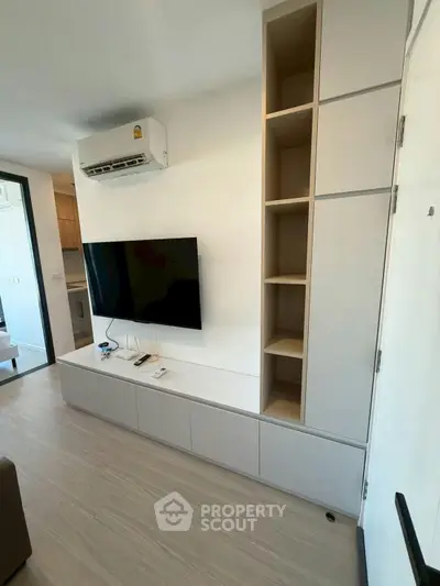 Modern living room with wall-mounted TV and built-in storage unit