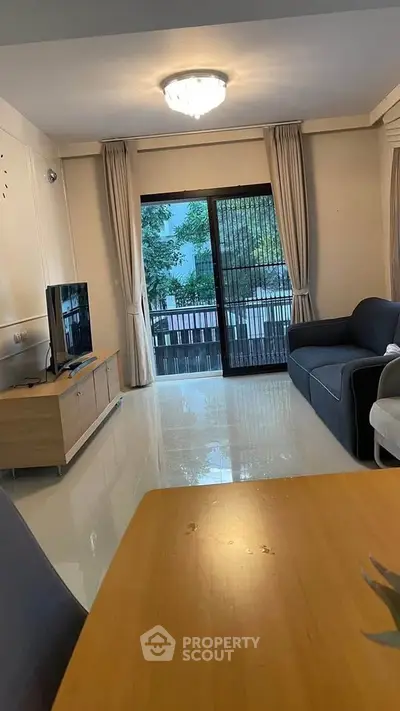 Spacious living room with modern furniture and large window view