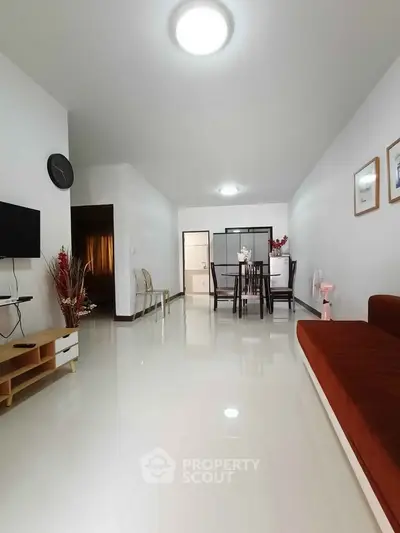 Spacious living room with modern decor and dining area, perfect for family gatherings.