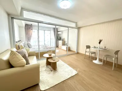 Stylish open-plan living room with cozy seating and elegant dining area