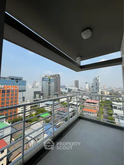 Spacious balcony with stunning city skyline view in modern high-rise building.