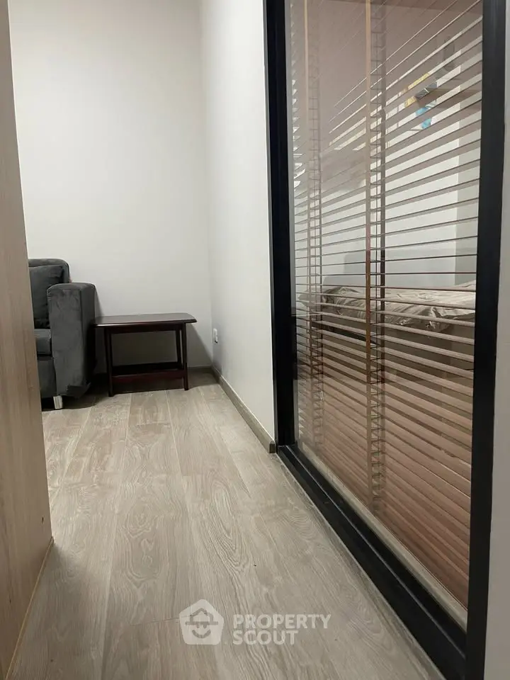 Modern apartment hallway with wooden flooring and glass partition