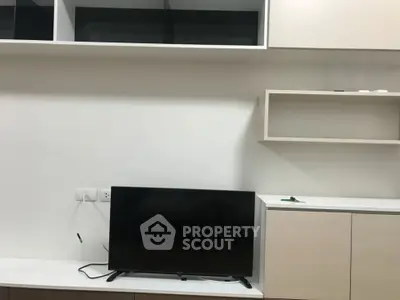 Modern living room with sleek TV setup and minimalist shelving