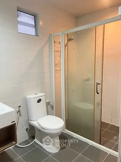 Modern bathroom with glass shower and sleek fixtures, perfect for contemporary living.