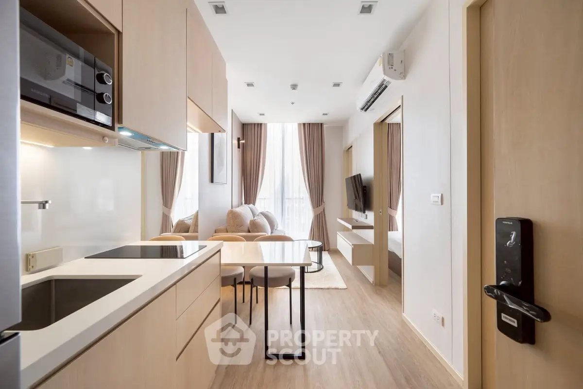 Modern open-layout kitchen and living room with sleek design and natural light