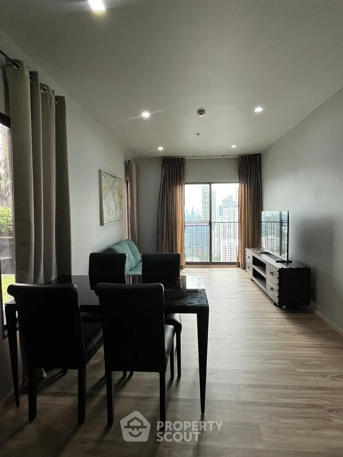 Spacious living room with modern decor and city view, perfect for urban living.