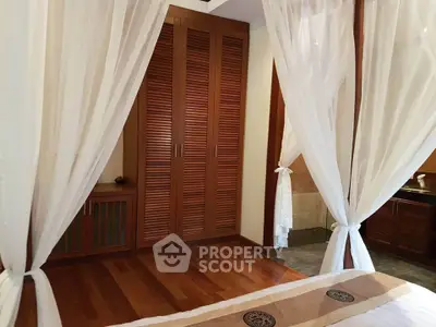 Luxurious bedroom with elegant wooden flooring and stylish curtains, perfect for a serene retreat.