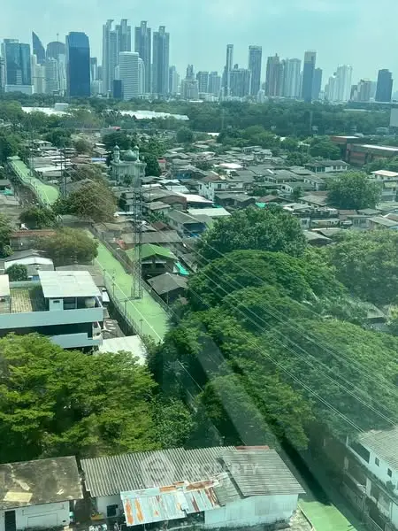 Stunning cityscape view showcasing a blend of urban skyline and lush greenery, perfect for real estate investment.