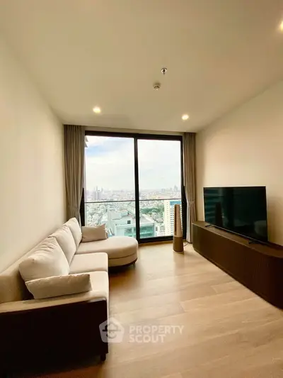 Modern living room with stunning city view, featuring sleek furniture and floor-to-ceiling windows.