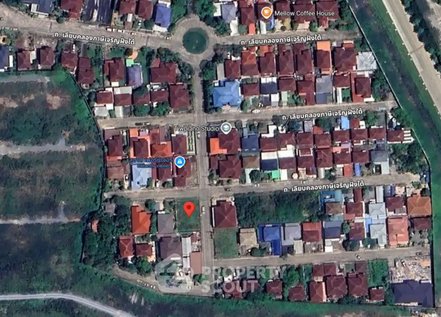 Aerial view of residential neighborhood with houses and streets in a grid layout.