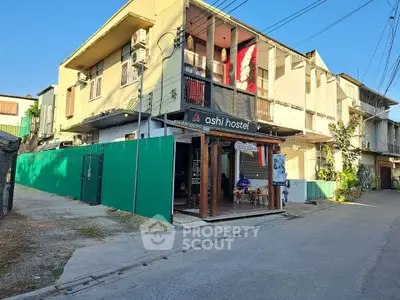 Charming hostel exterior with vibrant signage and street view