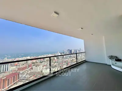 Spacious balcony with stunning city and ocean views, perfect for relaxation and entertaining.