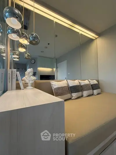 Modern living room with stylish lighting and cozy seating area, perfect for relaxation and entertaining.