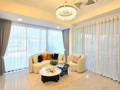 Elegant living room with modern chandelier and stylish furniture