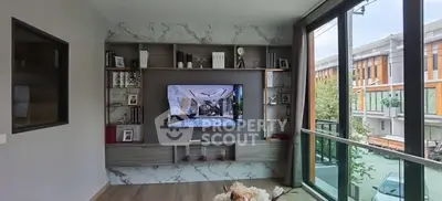 Modern living room with stylish shelving and large windows for natural light.