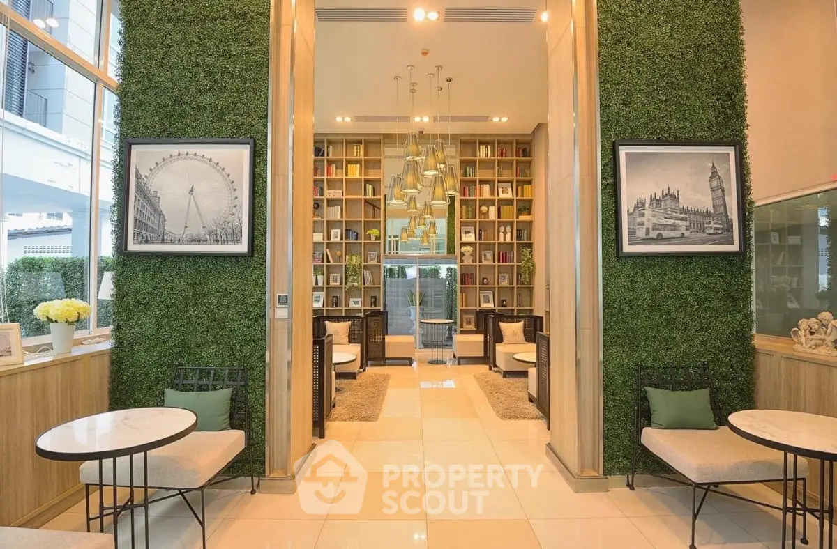 Luxurious modern lobby with green walls and elegant seating area, perfect for relaxation and social gatherings.