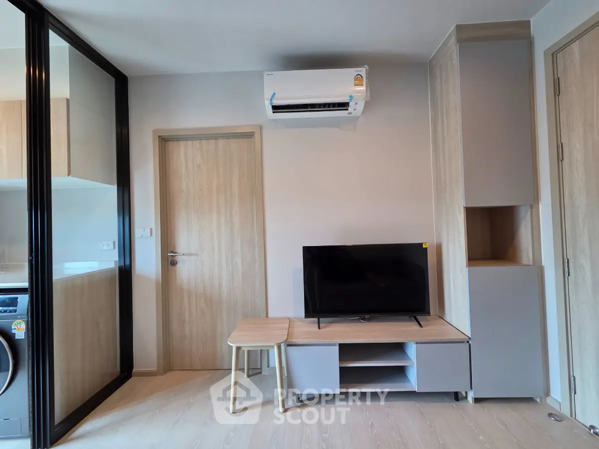Modern living room with sleek furniture and air conditioning in a stylish apartment.