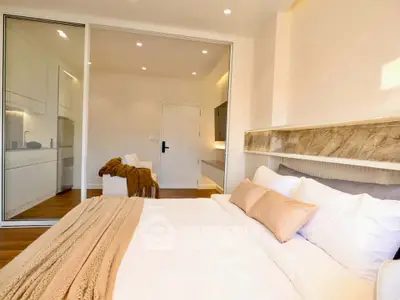 Luxurious bedroom with modern design and cozy ambiance, featuring elegant decor and ample natural light.