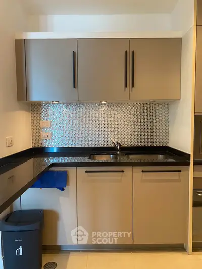Modern kitchen with sleek cabinets and mosaic backsplash