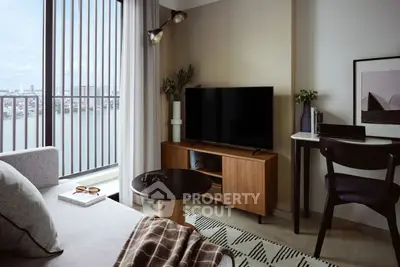 Modern living room with stylish decor and stunning city view from balcony.