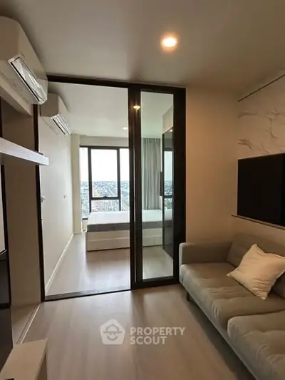 Modern apartment interior with cozy living room and bedroom view