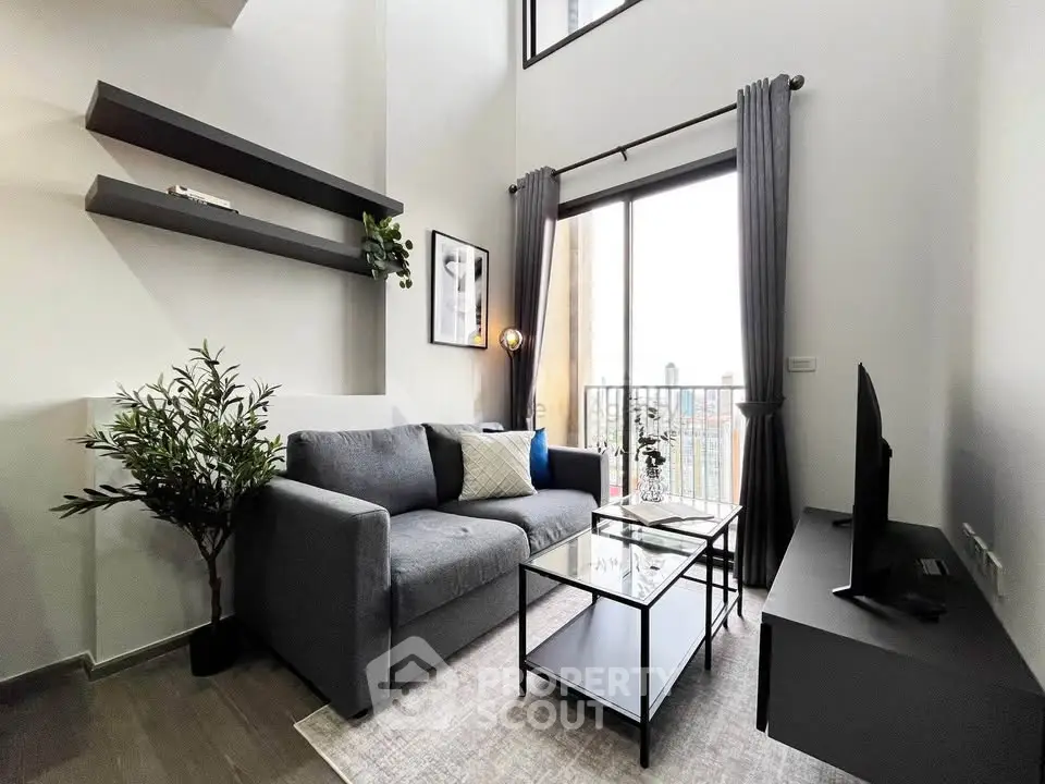 Modern living room with high ceiling and balcony view, featuring sleek furniture and stylish decor.