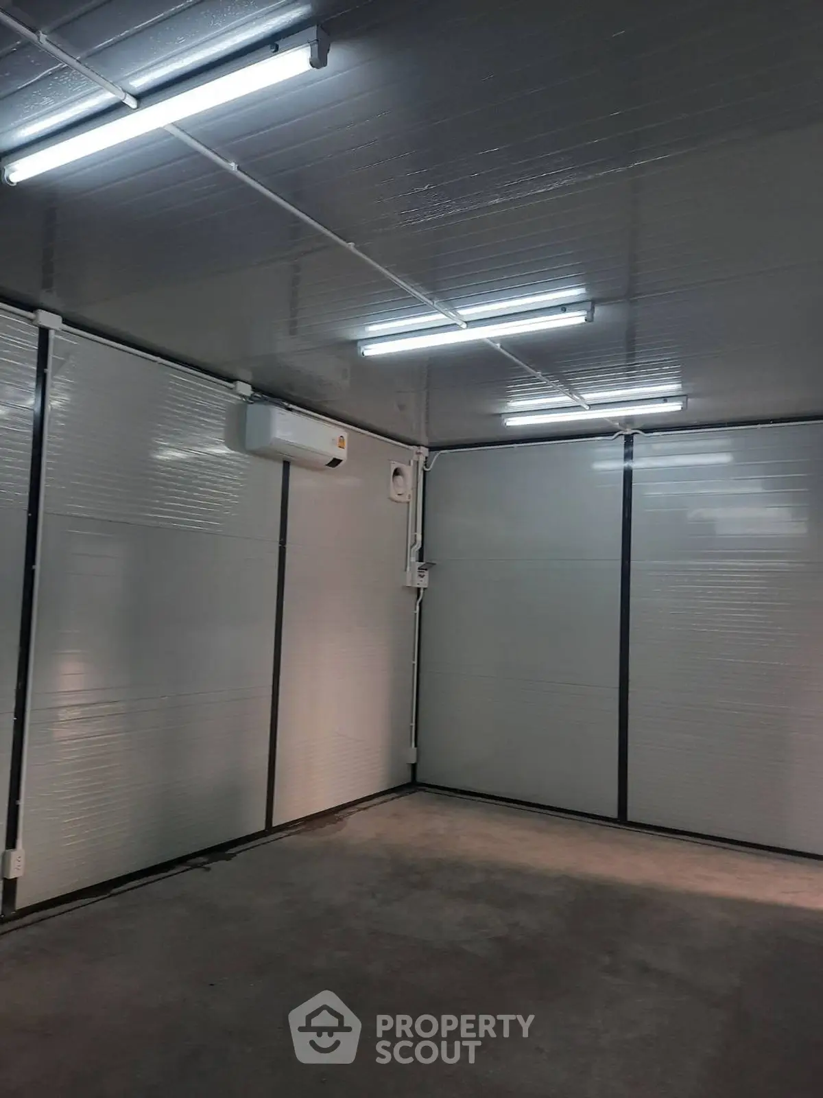 Spacious storage unit with modern lighting and climate control, ideal for secure storage solutions.