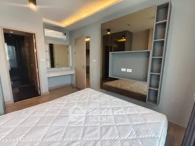 Modern bedroom with built-in storage and stylish lighting in a contemporary apartment.