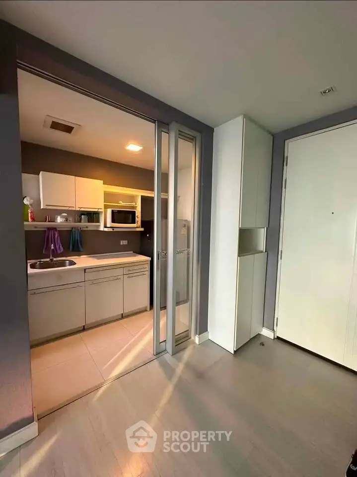 Modern kitchen with sleek cabinetry and built-in appliances in a stylish apartment.