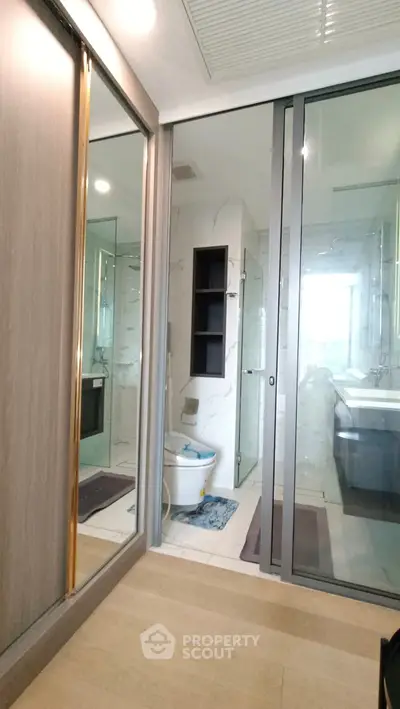 Modern bathroom with glass doors and sleek fixtures