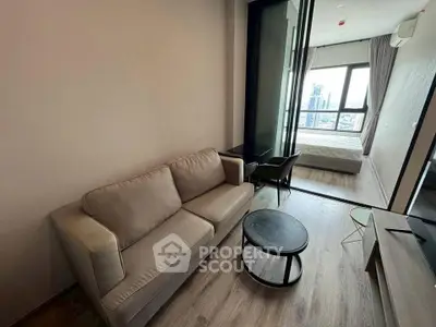 Modern apartment interior with cozy living room and bedroom view, featuring stylish furniture and cityscape backdrop.