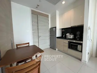Modern kitchen with sleek cabinets and dining area in a stylish apartment