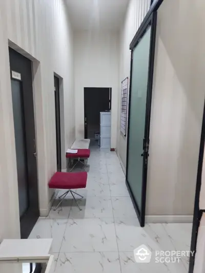 Modern hallway with glass doors and stylish benches in a contemporary building