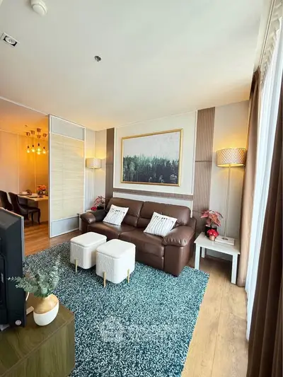 Stylish living room with leather sofa, modern decor, and large window for natural light.