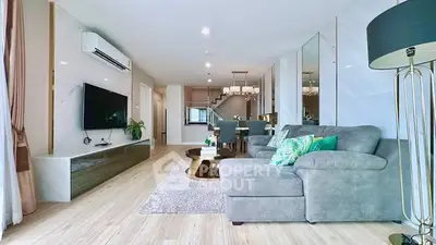 Spacious modern living room with elegant decor and open dining area