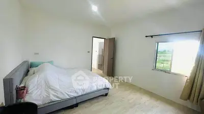 Bright and airy bedroom with scenic window view and modern decor