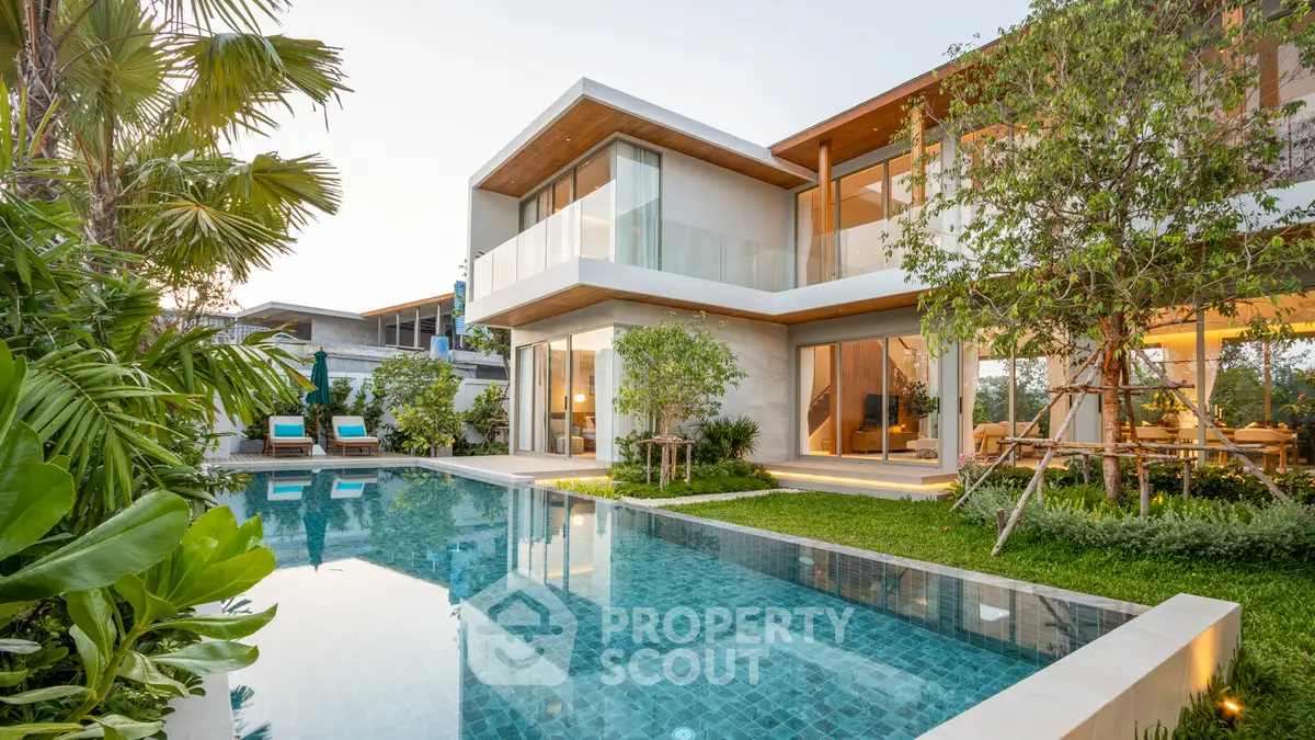 Luxurious modern villa with stunning pool and lush garden, perfect for serene living.