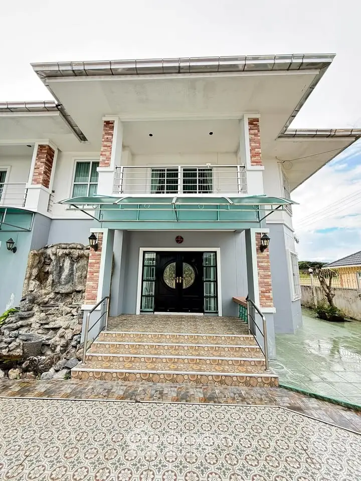 Stunning two-story house with elegant entrance and modern architectural design.