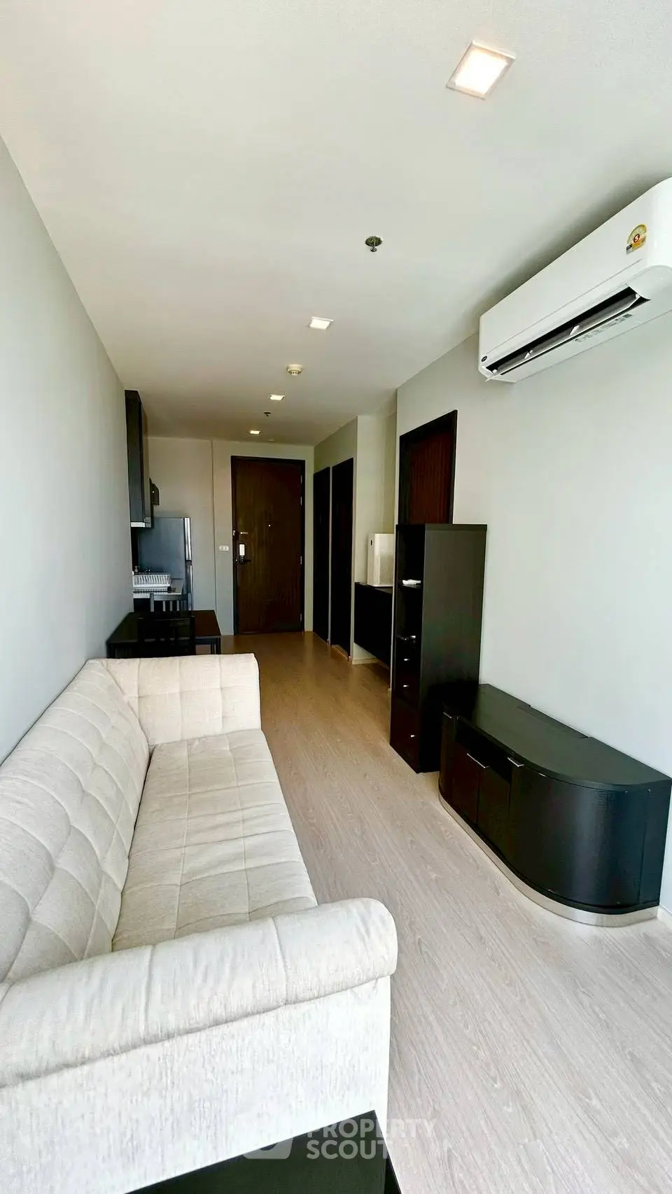 Modern living room with sleek furniture and air conditioning in a stylish apartment.