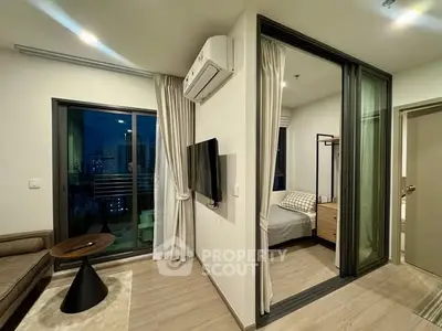 Modern apartment interior with cozy living room and bedroom, featuring sleek furniture and city view balcony.