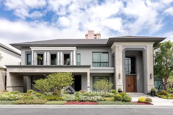 Luxurious modern two-story house with landscaped garden and elegant facade.