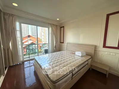 Spacious bedroom with balcony and city view in modern apartment