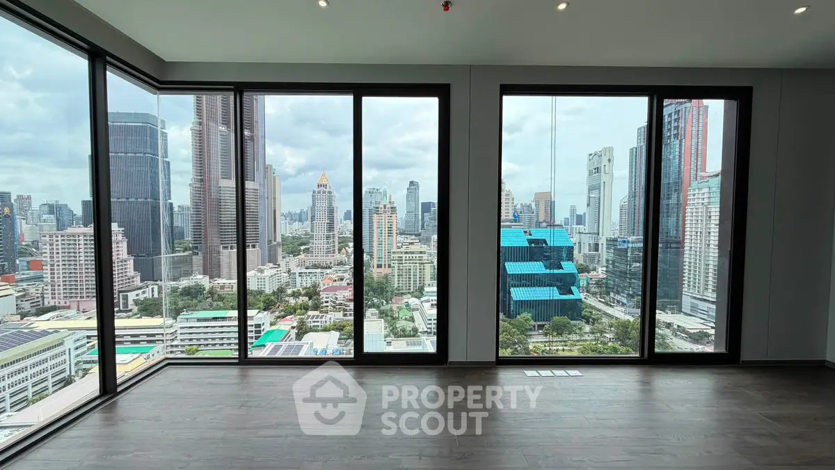 Stunning corner unit with floor-to-ceiling windows offering panoramic city views in a modern high-rise.