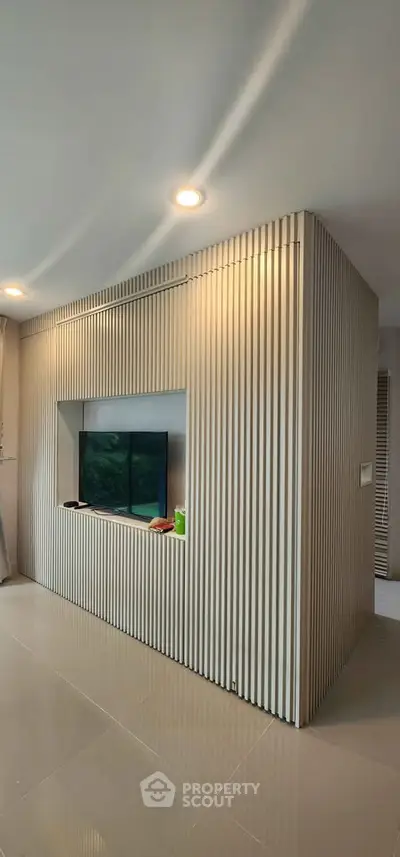 Modern living room with sleek TV wall design and ambient lighting