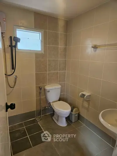 Modern bathroom with sleek tile design and essential fixtures